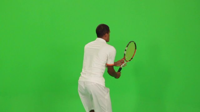 Professional tennis player makes different types of shots on a green screen.Session with professional tennis player