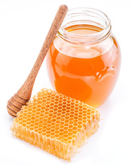 Jar full of fresh honey and honeycombs. High-quality picture.