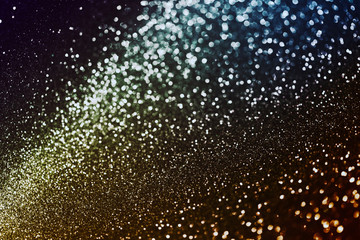 Naklejka na ściany i meble Abstract bokeh background with fantastic sparkle effect in dark colors, texture of blur gold and blue lights, can be used as theme of galaxy, space or universe