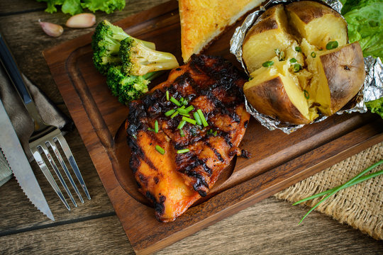 Grilled Fillet Of Chicken Steak With Mash Potato On Wooden Table