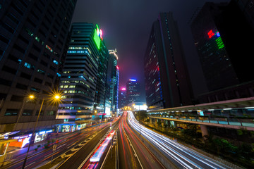 Fototapeta na wymiar Mist Hong Kong Central District at Night with Light Track