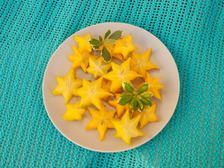 Exotic tropical fruit carambola lies on a plate