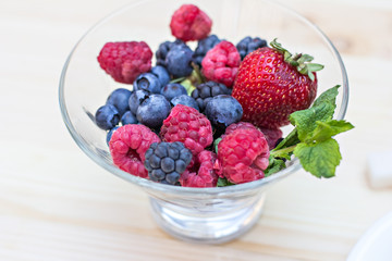Summer berries (strawberries, raspberries, blueberries, blackberries) and a cup of coffee 