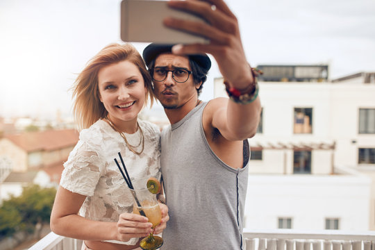 Young couple taking a selfie on the roof
