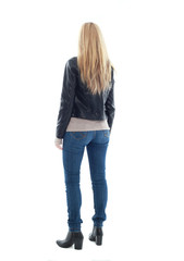 Obraz premium beautiful blonde woman wearing leather jacket and blue jeans, standing pose. isolated on white background.