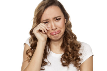 weeping beautiful girl on a white background