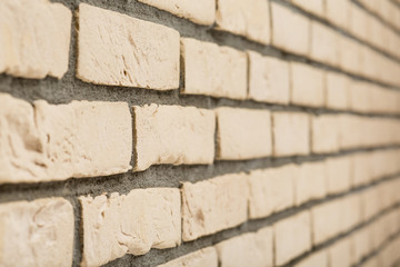 Beige brick wall in perspective