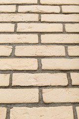 Beige brick wall texture from a low angle perspective