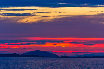 Sunset at sea, with small greek islands in background, Sithonia, Greece