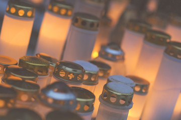 Candles in the graveyard during the night. This image is suitable for example for text backgrounds, website backgrounds, or anything else. Image has a vintage effect.