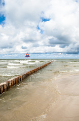 Landscape of sea with waves and cloudy sky.