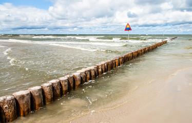 Landscape of sea with waves and breakwater. Summer view.