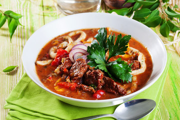 Lagman with meat clay pot wooden board still life green bright beautiful appetizing, delicious food