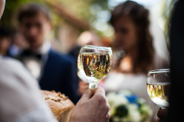 man holding elegant glass of champagne in a restaurant celebrati