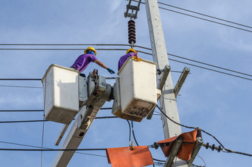 Electrical repairs on a power pole