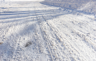Fototapeta na wymiar Background of tire tracks in snow