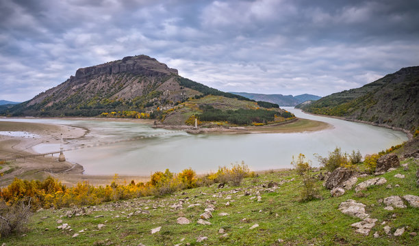 Autumn mountain. 
An amazing autumn view of Studen Kladenetz dam and the hill with Monyak fortress in the Eastern Rhodopes Mountains Bulgaria.