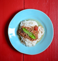 Italian spaghetti on red rustic wooden table
