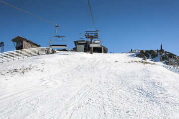 Fototapeta na wymiar Chair lift in Navacerrada Ski Resort, Navacerrada Mountain Pass, Madrid, Spain, on January 4, 2015.