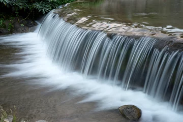 Foto auf Acrylglas white waterfall from small river © sabthai