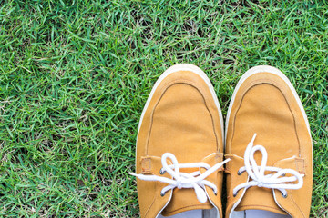 Sneakers on grass, top view, copy space