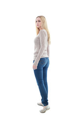 Obraz premium beautiful young woman with long blonde hair wearing a long sleeved cream shirt and gold necklace. standing pose, isolated on white background.