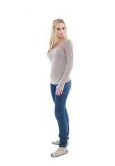 Obraz premium beautiful young woman with long blonde hair wearing a long sleeved cream shirt and gold necklace. standing pose, isolated on white background.
