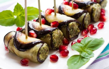 Eggplant rolls with nuts. Delicious starter of fried aubergines with nuts, herbs and pomegranate seeds
