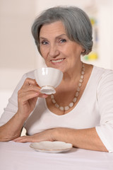 Senior woman with cup of coffee