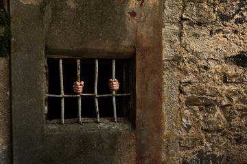 Man in prison and behind grate