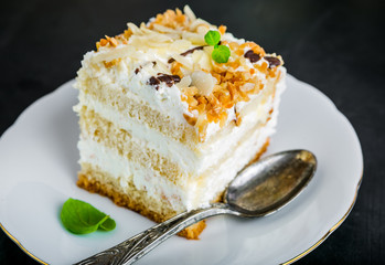 Serving cake with a creamy cream and nuts