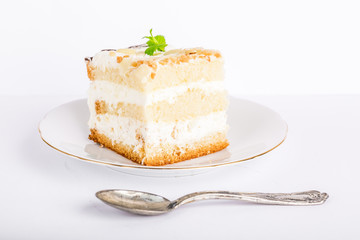 Serving cake with a creamy cream isolated on white