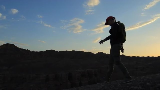 Young girl walking through the Canyons at sunset
