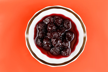 Homemade cherry jam on a saucer. View from above.