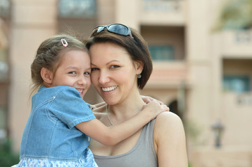 Mother with  daughter near hotel