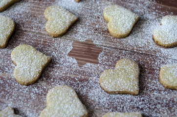 Biscuits in the shape of a heart and star on a dark wooden background