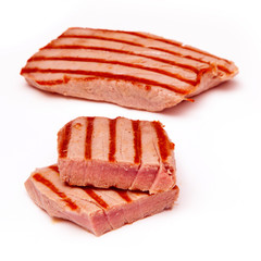 Cooked Yellowfin tuna fish steaks isolated on a white background