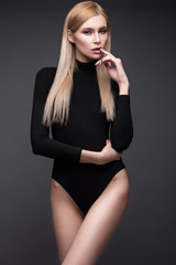 Naklejka premium sexy fashion model with long hair, young European attractive, beautiful eyes, full lips, perfect skin is posing in studio for glamour vogue test photo shoot showing different poses