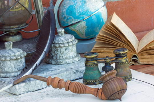 фрагмент рабочего стола с книгой,глобусом,трубкой курительной,биноклем