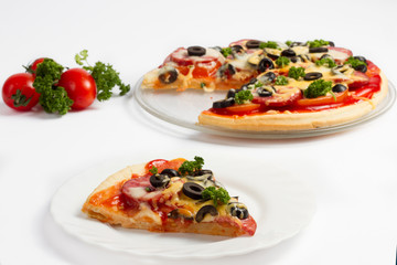 Pizza with tomatoes, salami, cheese and olives