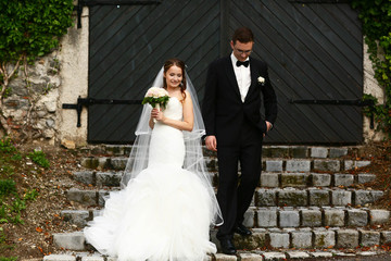 gentle stylish couple on the background  green ivy wall, road, d