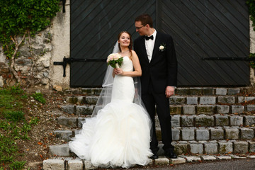 gentle stylish couple on the background  green ivy wall, road, d