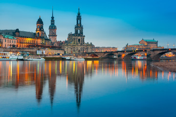 Fototapeta na wymiar Dresden Cathedral of the Holy Trinity or Hofkirche, Bruehl's Terrace or The Balcony of Europe, Semperoper and Augustus Bridge with reflections in the river Elbe at night in Dresden, Saxony, Germany