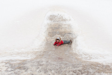 Fototapeta na wymiar a child riding a hill in winter