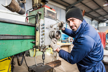 Worker at milling machine in workshop. © Riccardo Piccinini