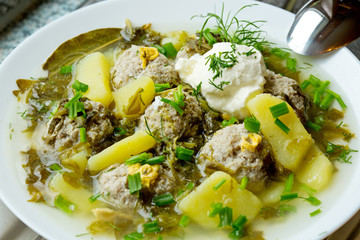 Sorrel soup with meatballs .