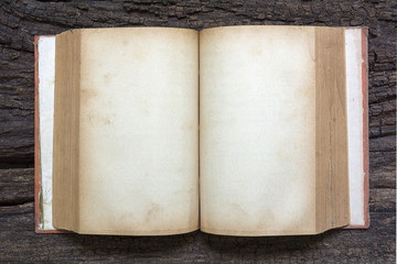 Open old book on wood