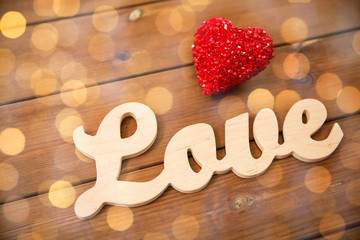 close up of word love with red heart decoration