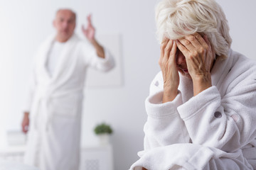 Elderly couple arguing in bedroom