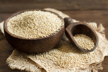 White Quinoa in a bowl with a wooden spoon